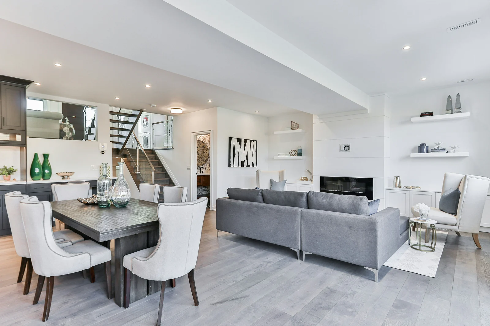 Vacation rental living area makeover with updated flooring and built-in shelving